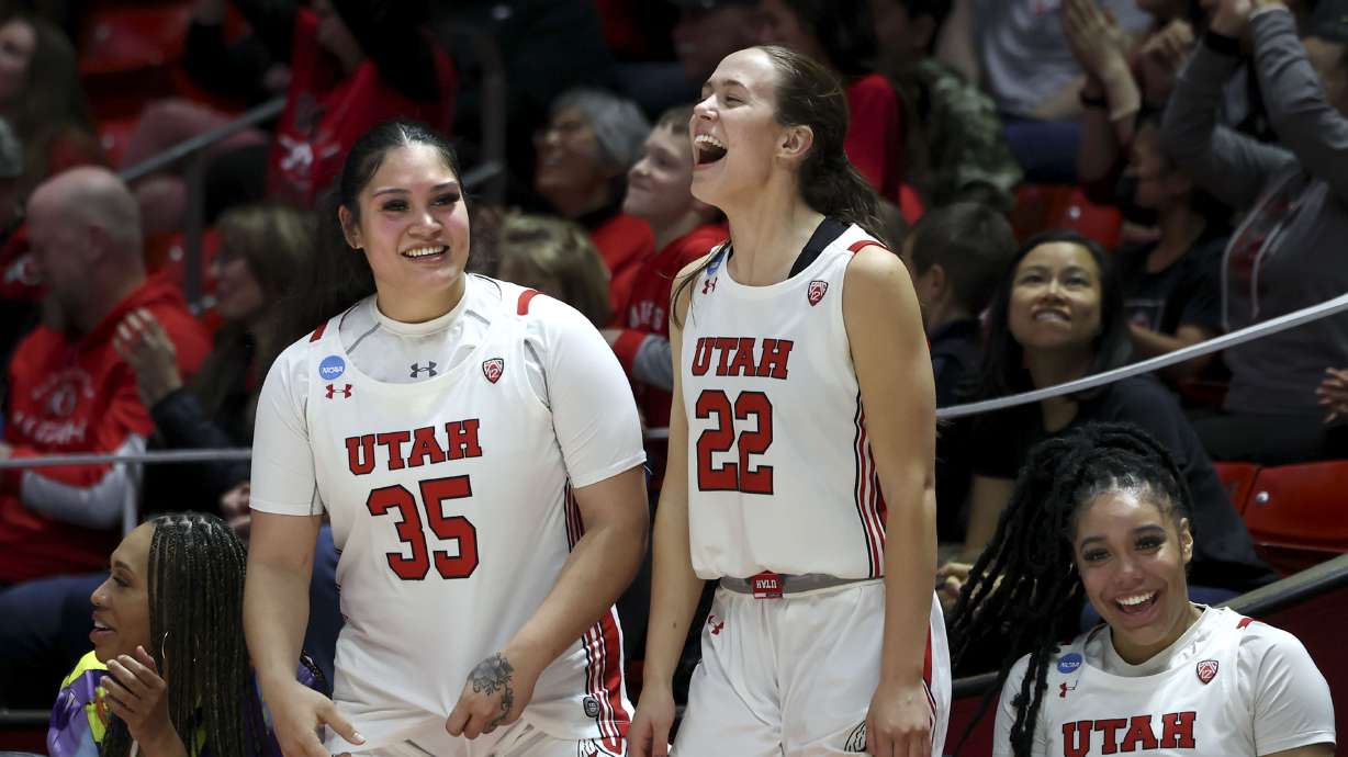 Utah Utes forward Alissa Pili (35) Jenna Johnson (22) and Teya Sidberry (32) cheer during the game against Gardner-Webb during the NCAA First Round at the Jon M. Huntsman Center in Salt Lake City on Thursday, March 16, 2023.