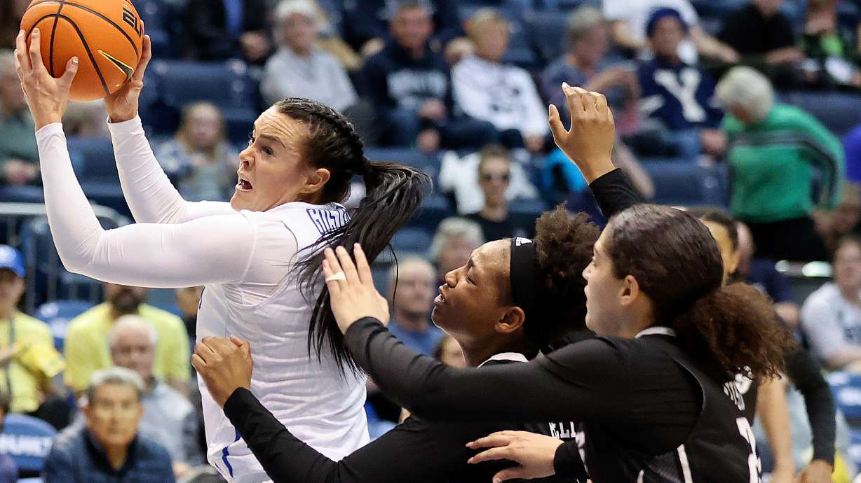BYU forward Lauren Gustin (12) reaches for a pass in front of Rice Owls forwards India Bellamy (12) and Ashlee Austin (22) during a Women’s National Invitation Tournament basketball game at the Marriott Center in Provo on Friday, March 17, 2023. BYU lost 71-67.