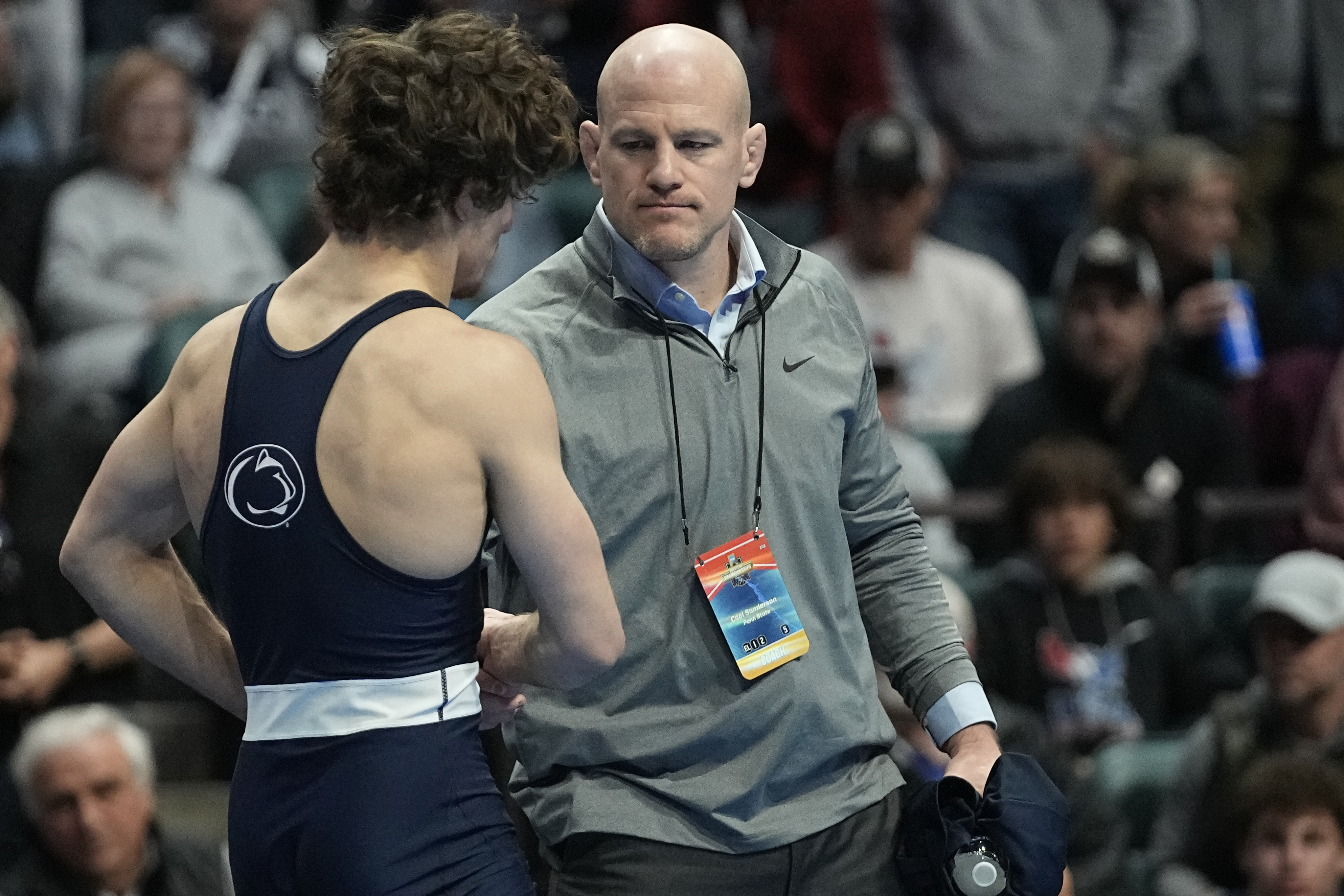 Penn State head coach Cael Sanderson, right, consoles Levi Haines after Haines was defeated by North Carolina's Austin O'Connor in the 157 lb. championship match the NCAA Wrestling Championships, Saturday, March 18, 2023, in Tulsa, Okla. 