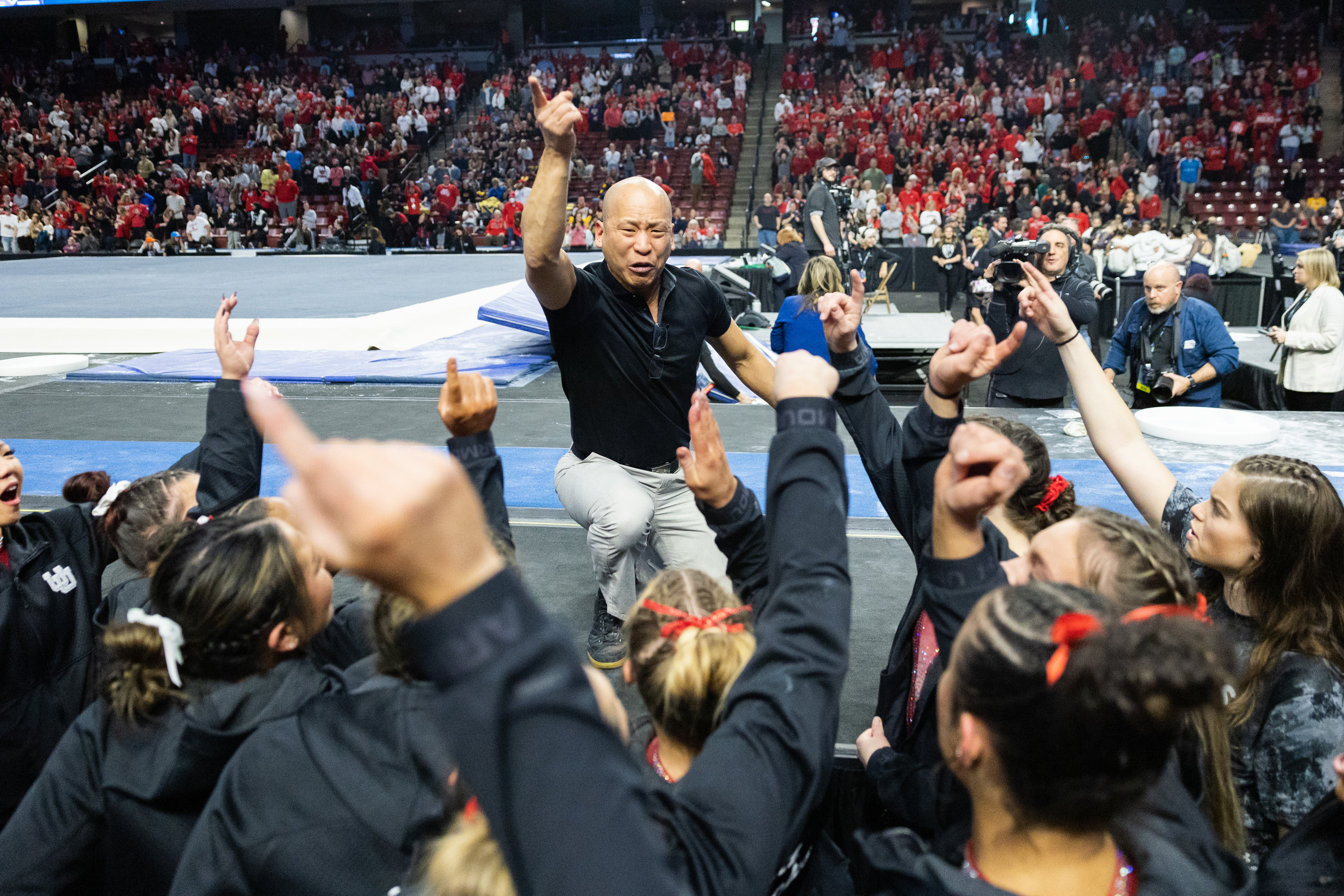 Utah’s head coach Tom Farden leads the team in a chant after winning the Pac-12 Gymnastics Championships at the Maverik Center in West Valley City on March 18, 2023.