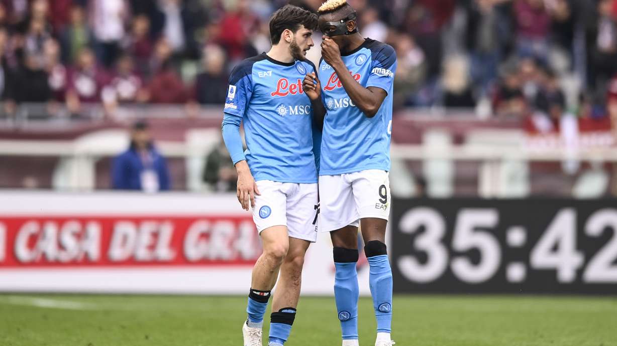 Napoli's Khvicha Kvaratskhelia, left, celebrates with Viktor Osimhen after scoring his side's 2nd goal during the Serie A soccer match between Torino and Napoli at the Turin Olympic stadium, Italy, Sunday, March 19, 2023.