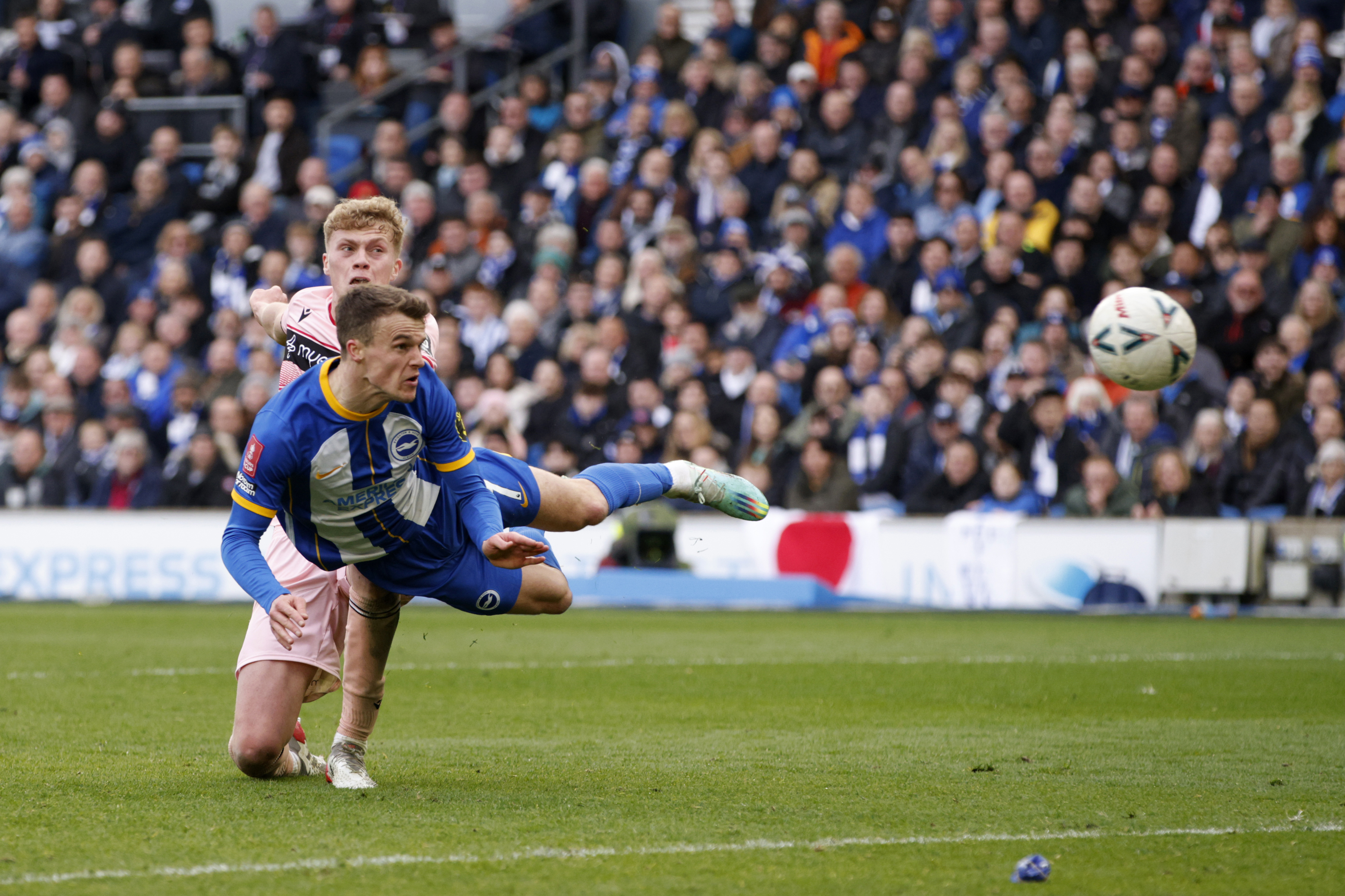 Brighton's Solly March, foreground, scores his side's fourth goal with a header during the English FA Cup quarterfinals soccer match between Brighton & Hove Albion and Grimsby Town at the AMEX Stadium in Brighton, England, Sunday, March 19, 2023.