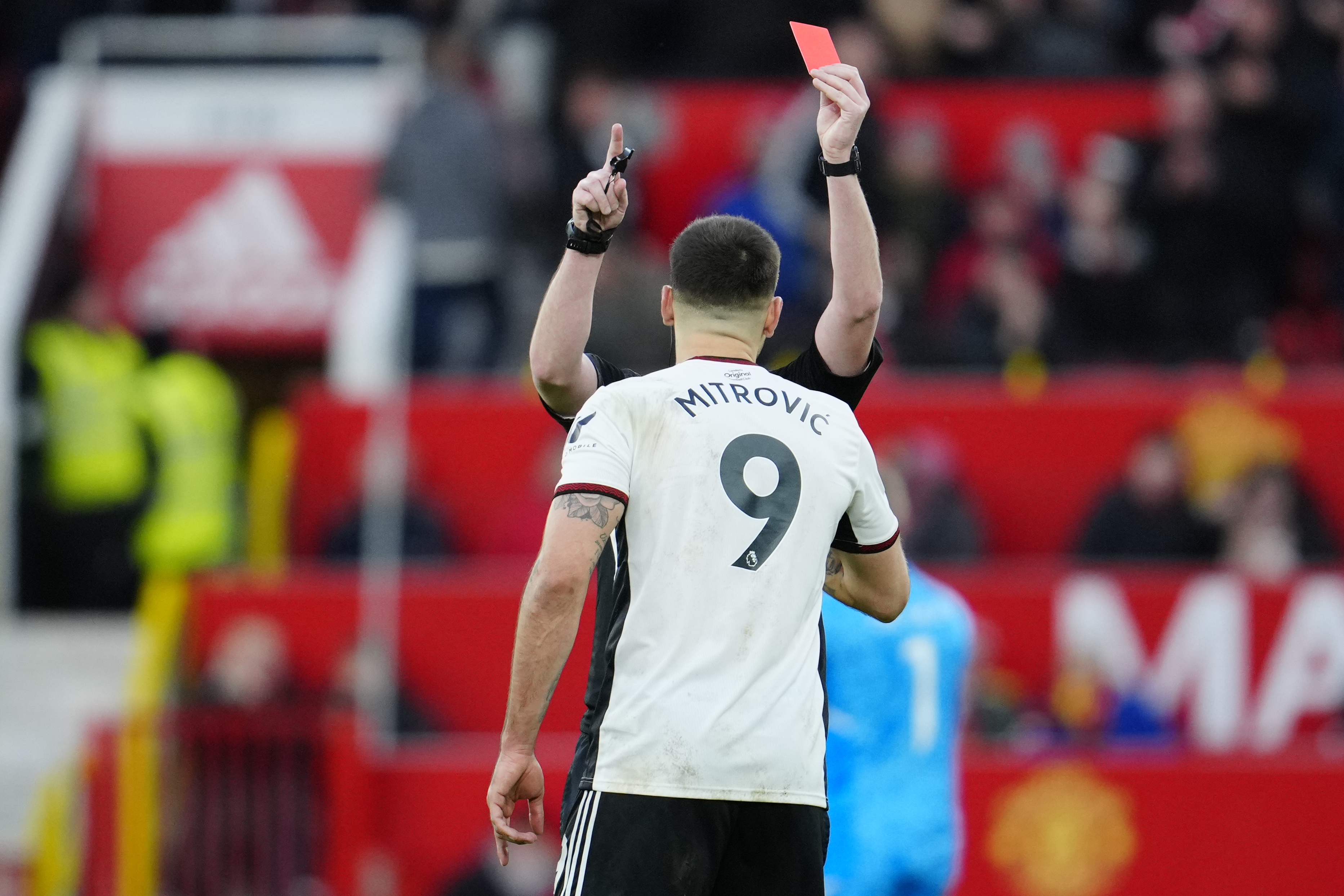 Fulham's Aleksandar Mitrovic is shown red card during the English FA Cup quarterfinal soccer match between Manchester United and Fulham at the Old Trafford stadium in Manchester, England, Sunday, March 19, 2023. 