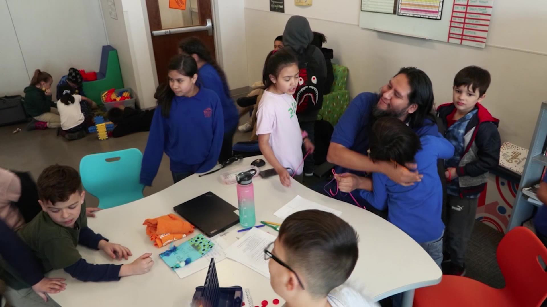 Students give Nate Manuel hugs showing their appreciation in this undated photo.
