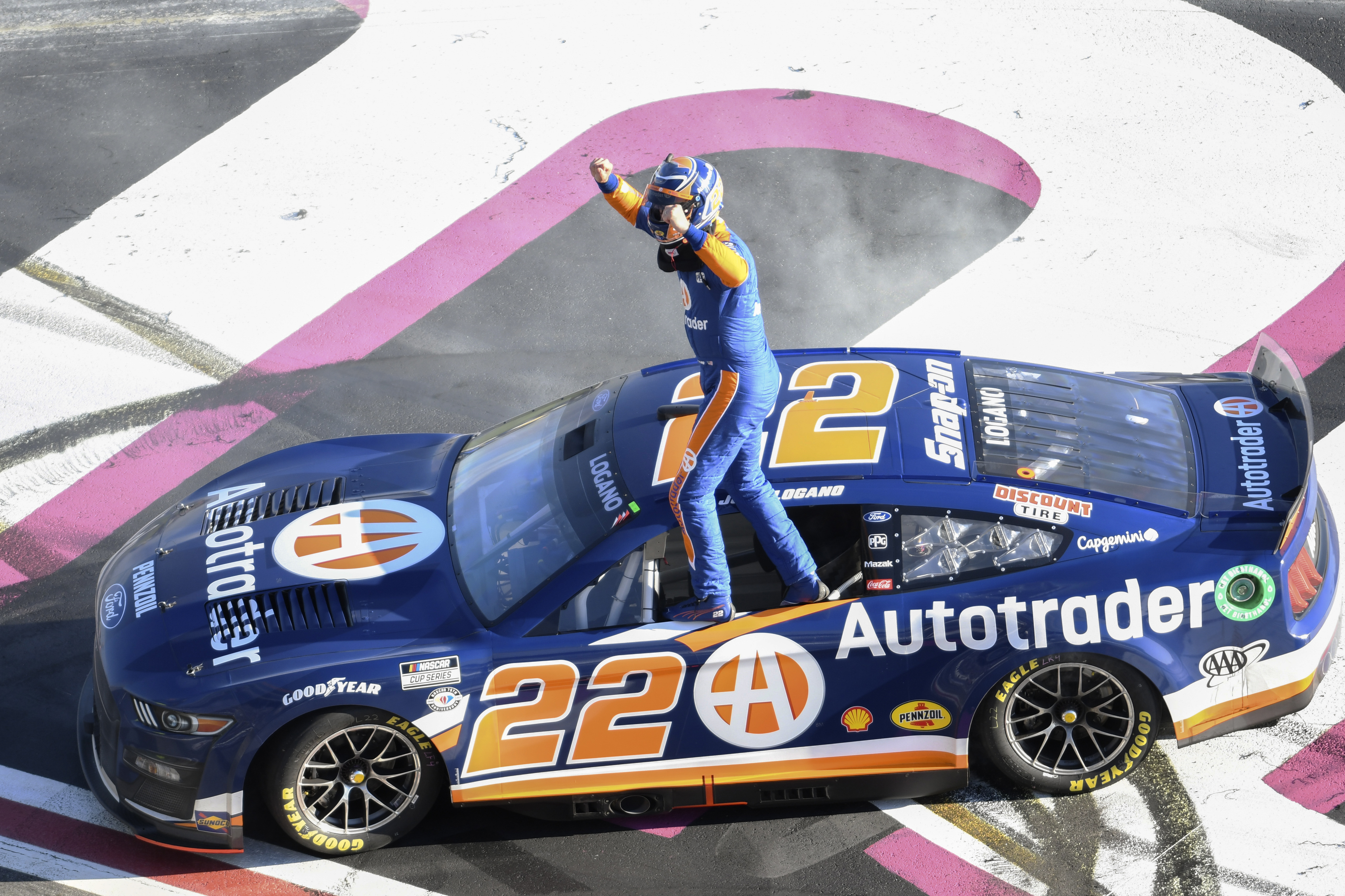 Joey Logano stands on his car after winning the NASCAR Cup Series auto race at Atlanta Motor Speedway on Sunday, March 19, 2023, in Hampton, Ga.