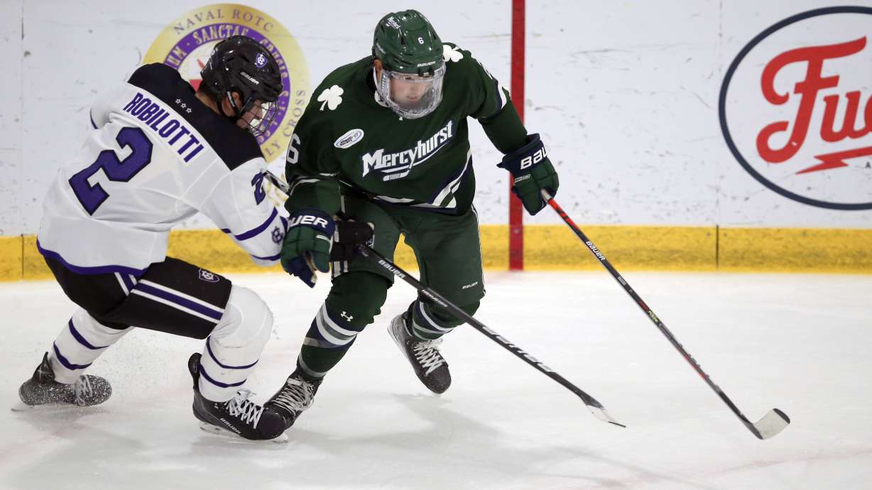 FILE - Holy Cross's Jack Robilotti (2) defends Mercyhurst's Carson Briere (6) during the first half of an NCAA hockey game on Friday, Nov. 12, 2021, in Worcester, Mass. The son of Philadelphia Flyers interim general manager Danny Briere has apologized after a video posted on social media showed him pushing an empty wheelchair down a set of stairs. Mercyhurst University hockey player Carson Briere issued his apology in a statement released by the NHL’s Flyers on Wednesday, March 15, 2023.
