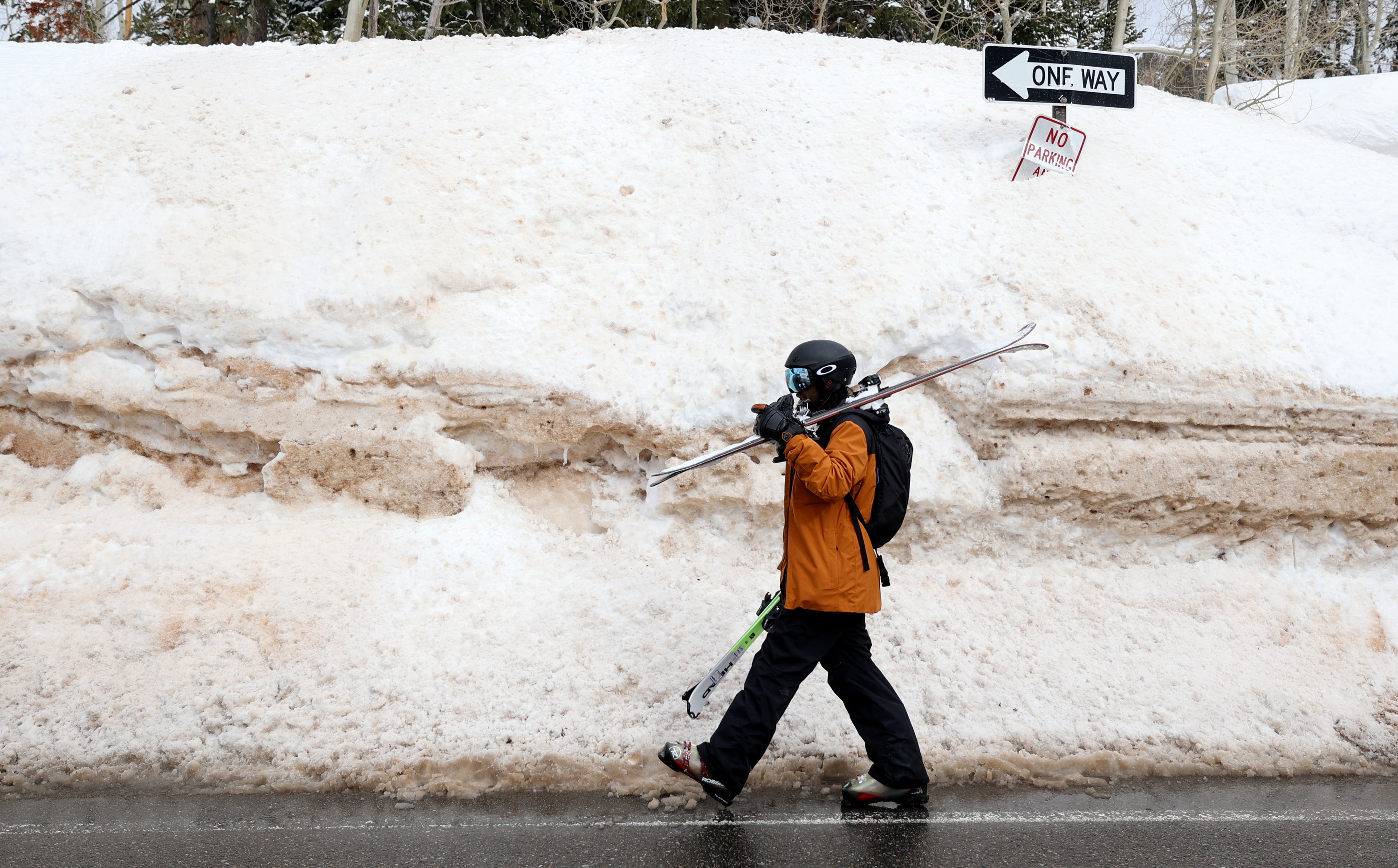 Ankur Patel walks beside a large snowbank in Brighton on March 13, 2023. Utah's record snowfall last year led to more than $2.6 billion in overall spending in the ski industry, according to a new analysis released on Wednesday.