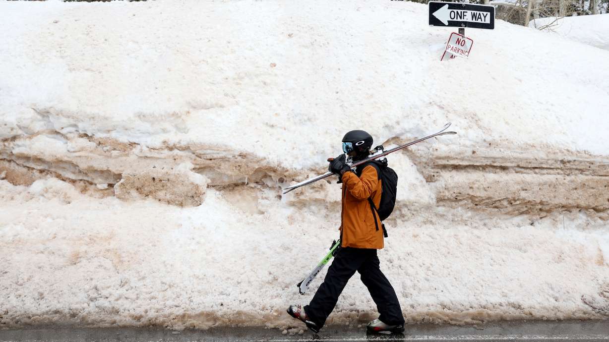 Ankur Patel walks beside a large snowbank in Brighton on March 13. Utah Gov. Spencer Cox is calling on Utahns of all faiths to pray to give thanks for all the precipitation that has fallen on Utah this water year.