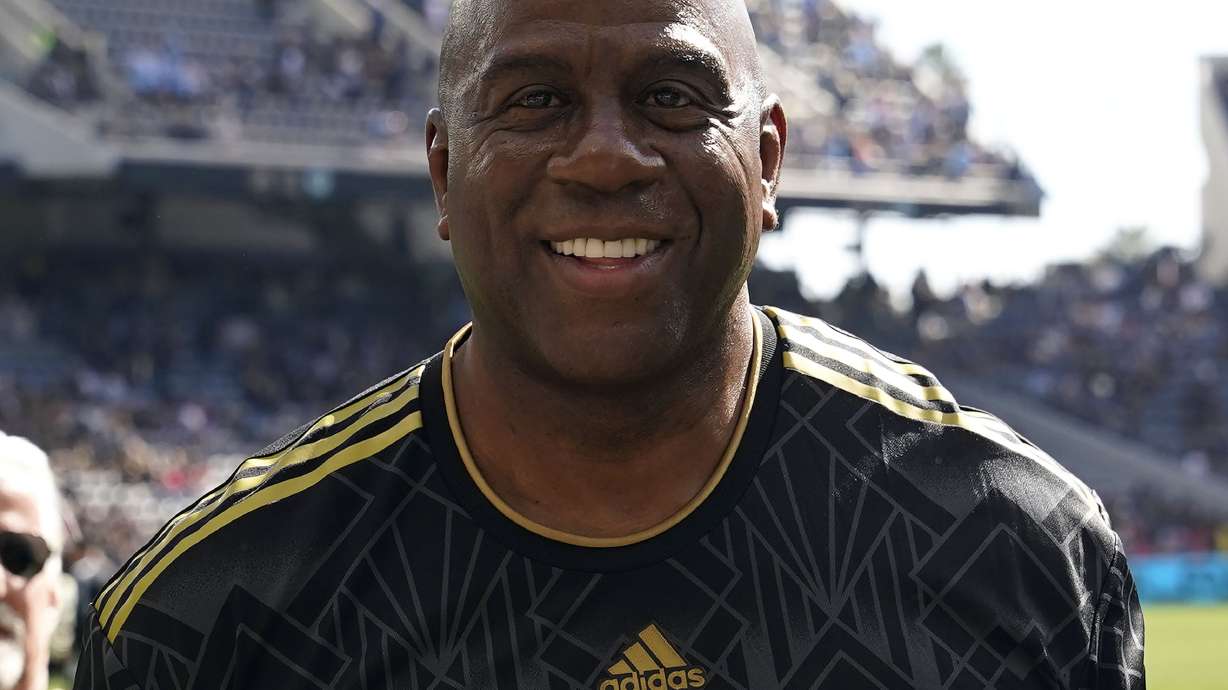 FILE - Former NBA player Magic Johnson smiles before an MLS Cup soccer match Nov. 5, 2022, in Los Angeles. Johnson has joined Josh Harris’ bid to buy the NFL’s Washington Commanders, a person with knowledge of the situation tells The Associated Press.