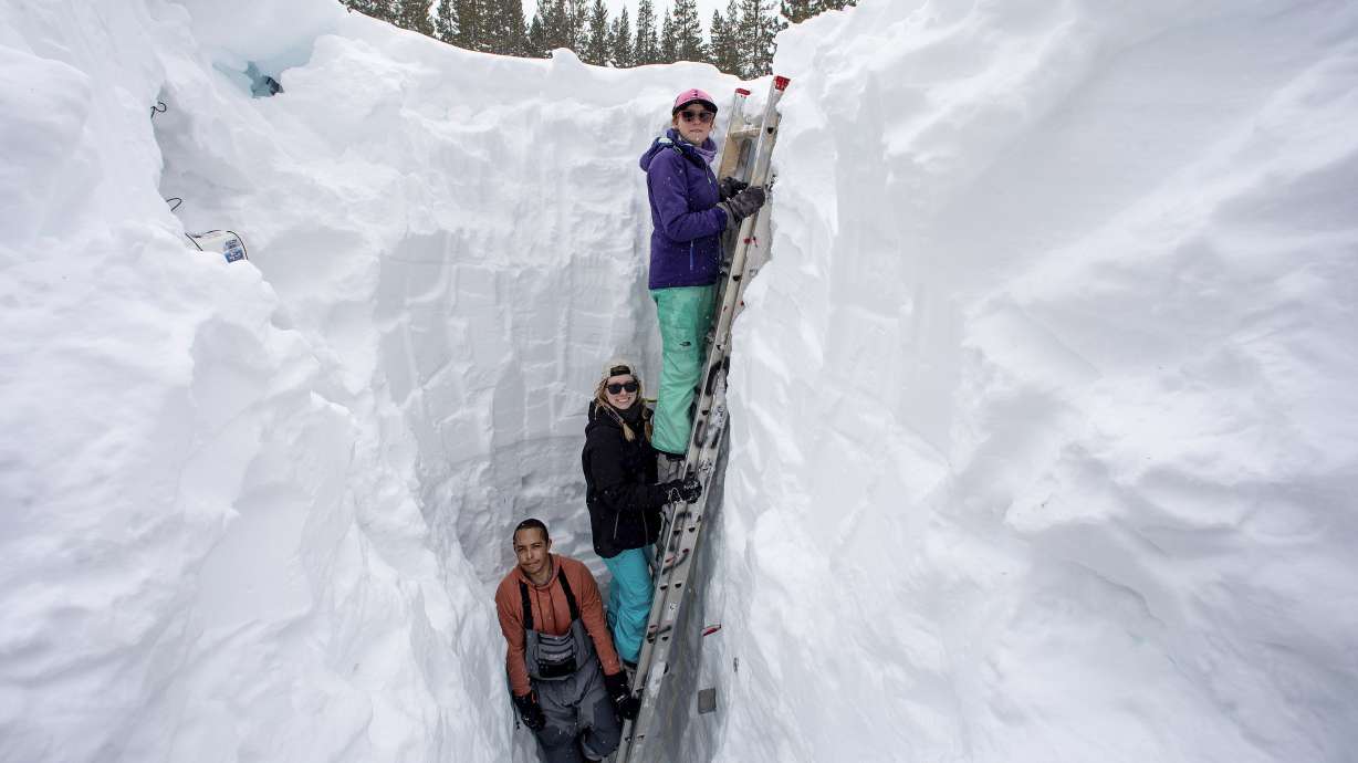 Shaun Joseph, Claudia Norman and Helena Middleton take measurements of snow temperatures ahead of a weather storm on March 9 in Soda Springs, Calif. It's been the second snowiest on record at the Central Sierra Snow Lab.