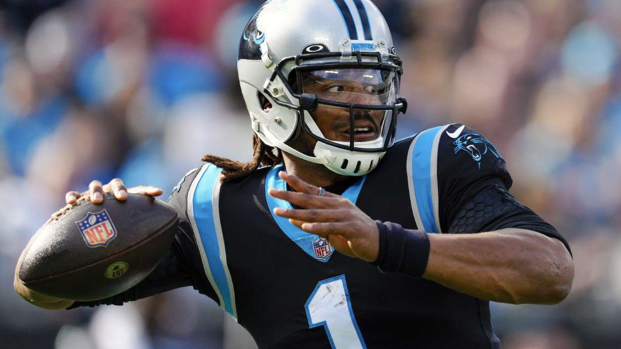 FILE - Carolina Panthers quarterback Cam Newton passes against the Tampa Bay Buccaneers during the first half of an NFL football game on Dec. 26, 2021, in Charlotte, N.C. Newton is looking for another shot. The 2015 NFL Most Valuable Player announced on social media that he’ll be working out for pro scouts at Auburn’s Pro Day on Tuesday, March 21, 2023.