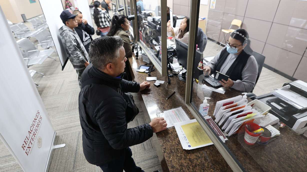 Luis Fernando Guerrero shows documentation for a passport at the Mexican Consulate in Salt Lake City on Dec. 21, 2022. The consulate has represented Mexican nationals and the broader Hispanic community in Utah for over a century.