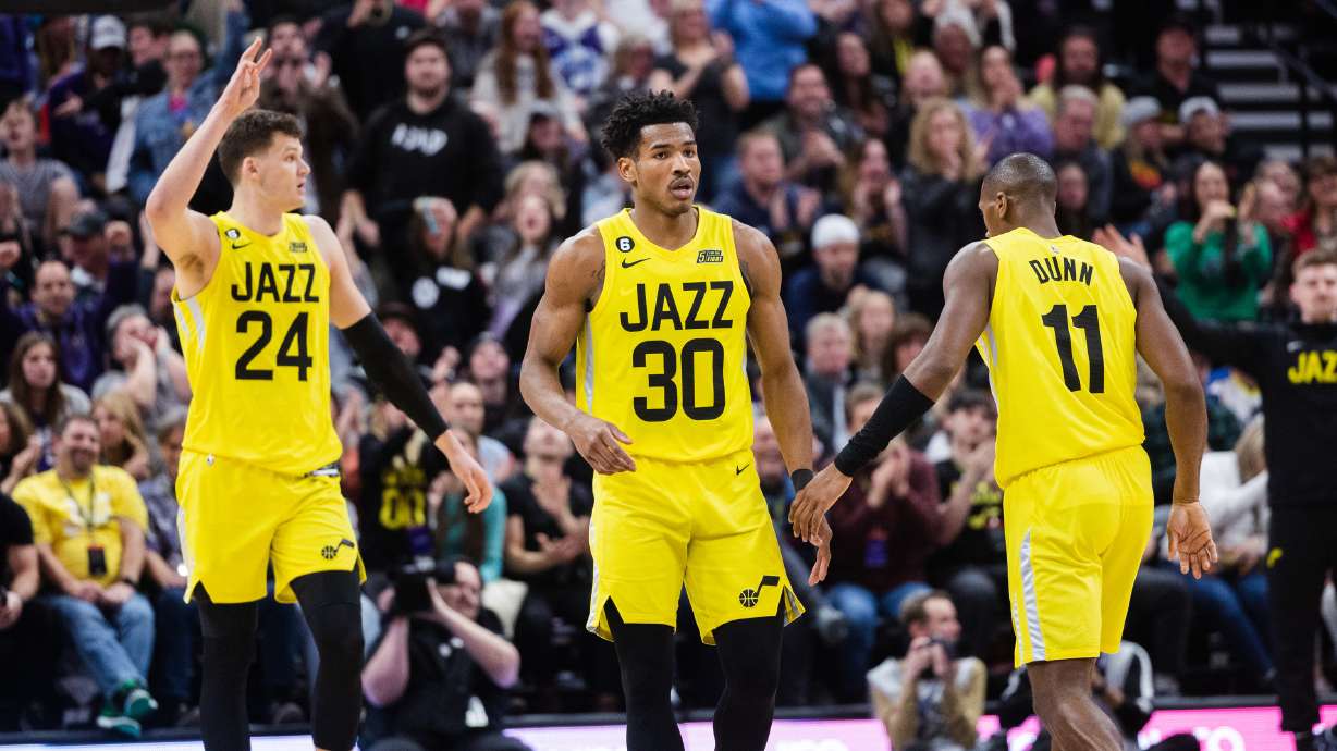 Utah Jazz guard Ochai Agbaji (30) high-fives teammate Utah Jazz guard Kris Dunn (11) during an NBA game against the Sacramento Kings at Vivint Arena in Salt Lake City on March 20, 2023.