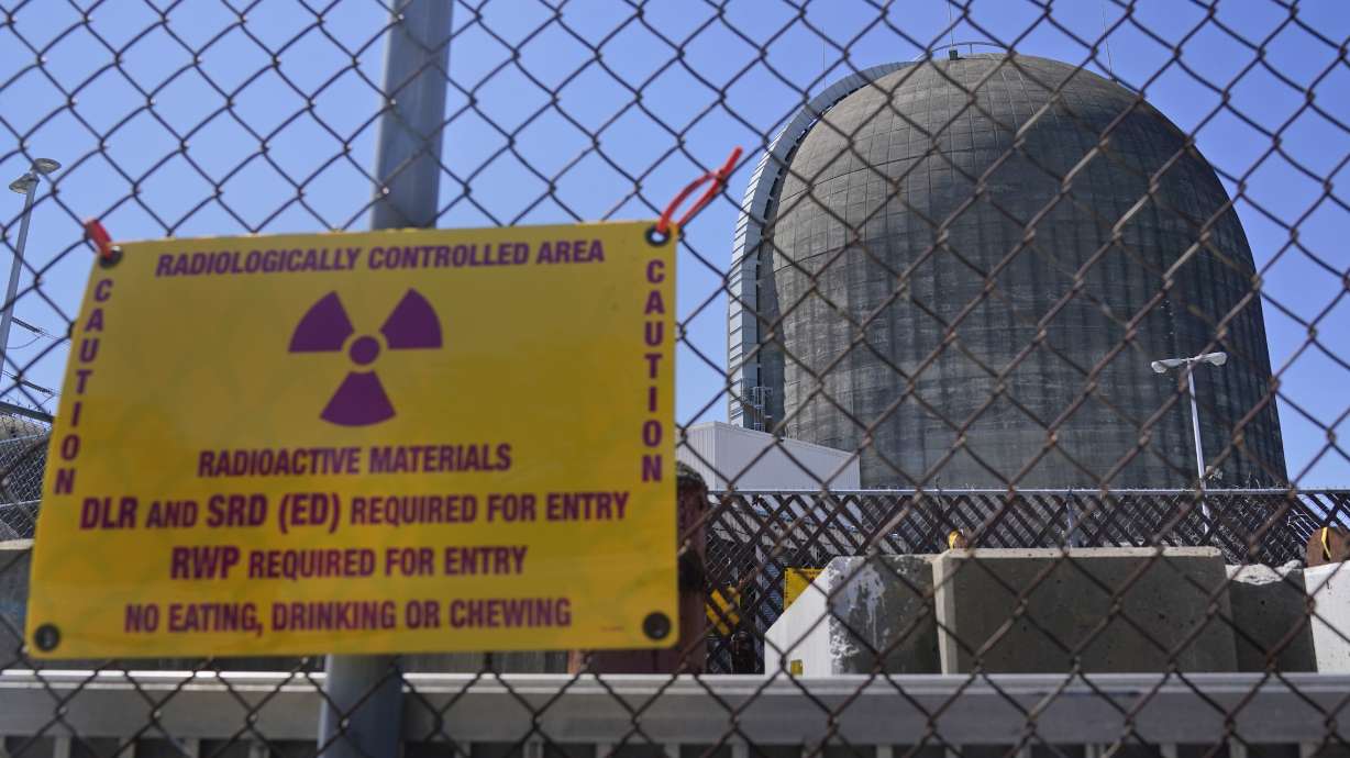 A sign warns of radioactive materials at a building housing a nuclear reactor at the Indian Point plant in Buchanan, N.Y., on April 26, 2021. U.S. regulators say they need more time to make a decision on whether to license a multibillion-dollar project.