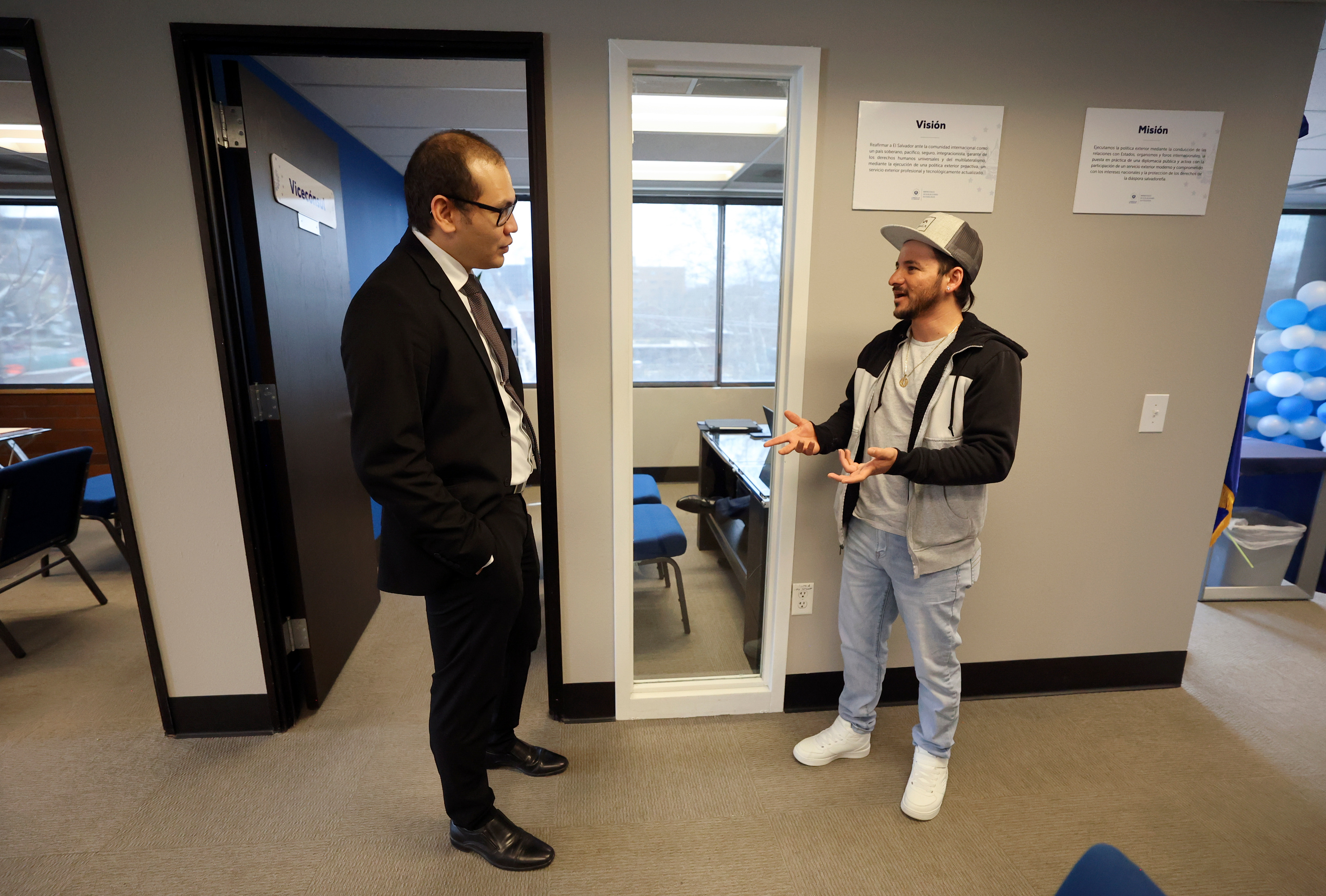 Fernando Perez, El Salvador consul general, talks with Jose Aviles at the consulate of El Salvador in Salt Lake City on Tuesday. The consul's opening of is part El Salvador's efforts to help those affected by the country's diaspora.