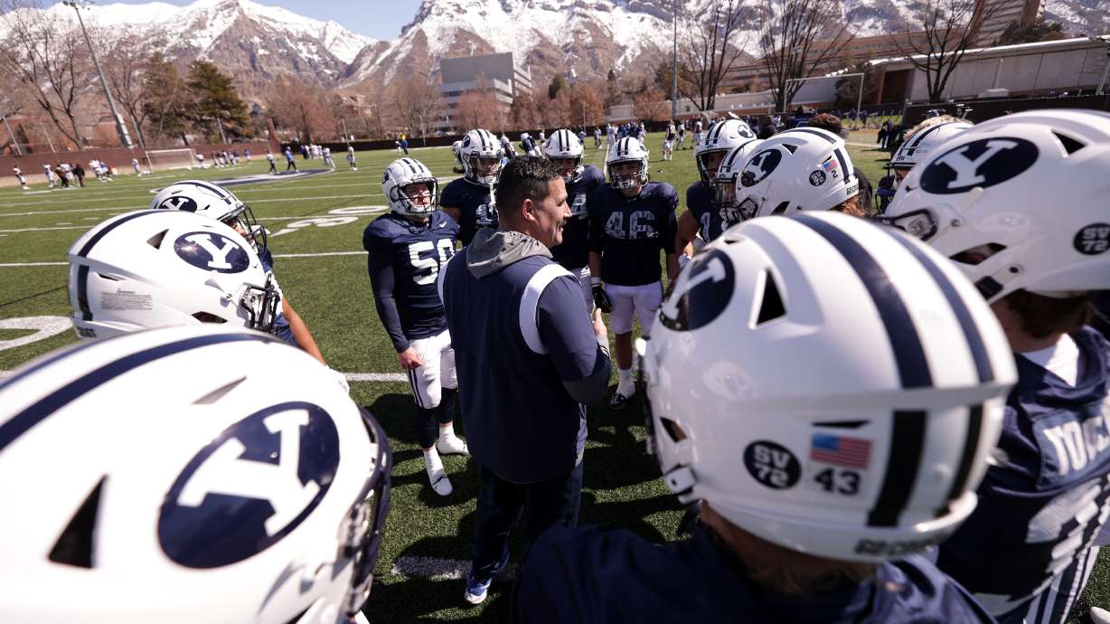 Linebackers Coach Justin Ena talks with his players after the BYU Cougars football practiced in Provo on Friday, March 17, 2023.