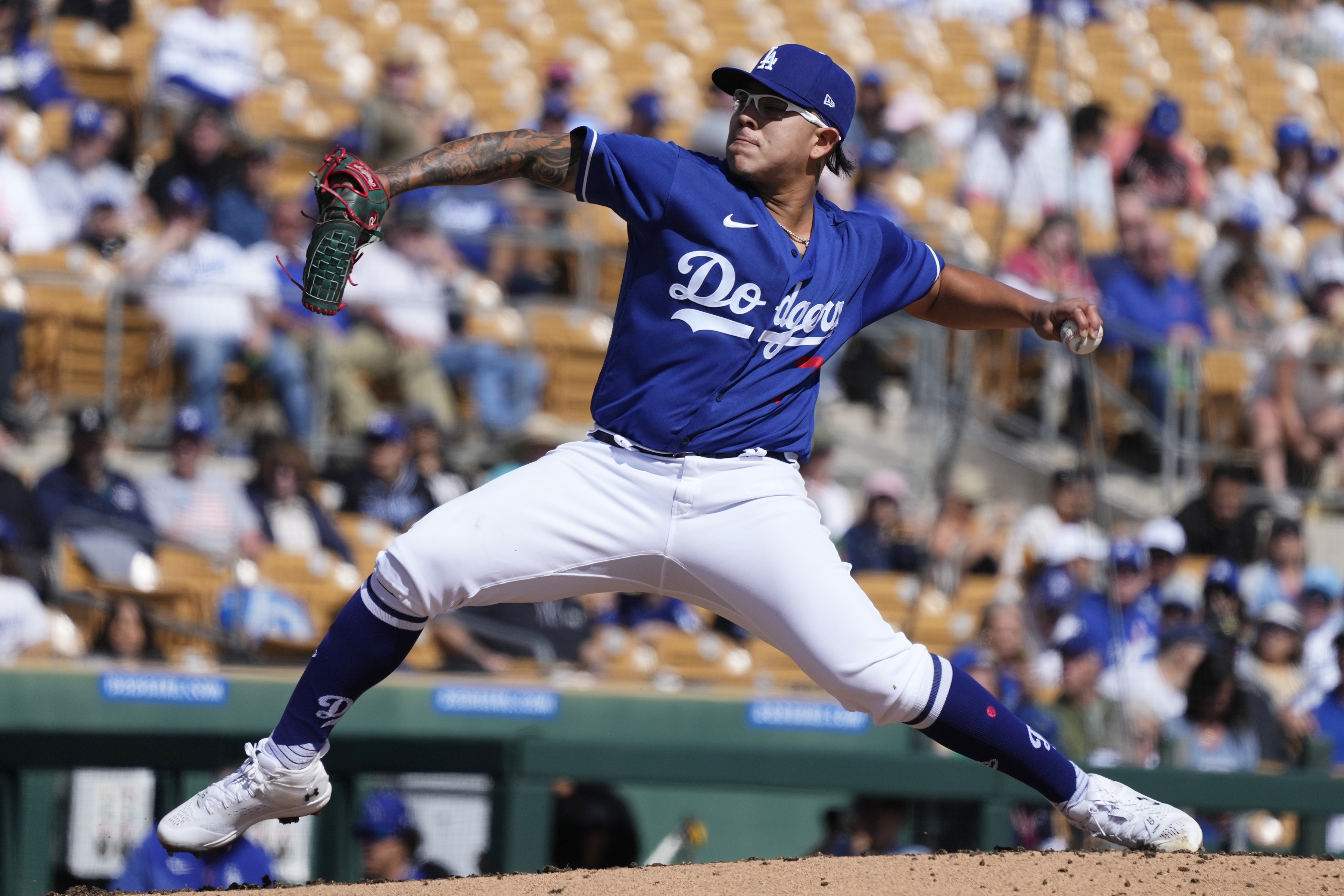 Los Angeles Dodgers starting pitcher Julio Urias throws a pitch against the Cincinnati Reds during the second inning of a spring training baseball game Tuesday, Feb. 28, 2023, in Phoenix.