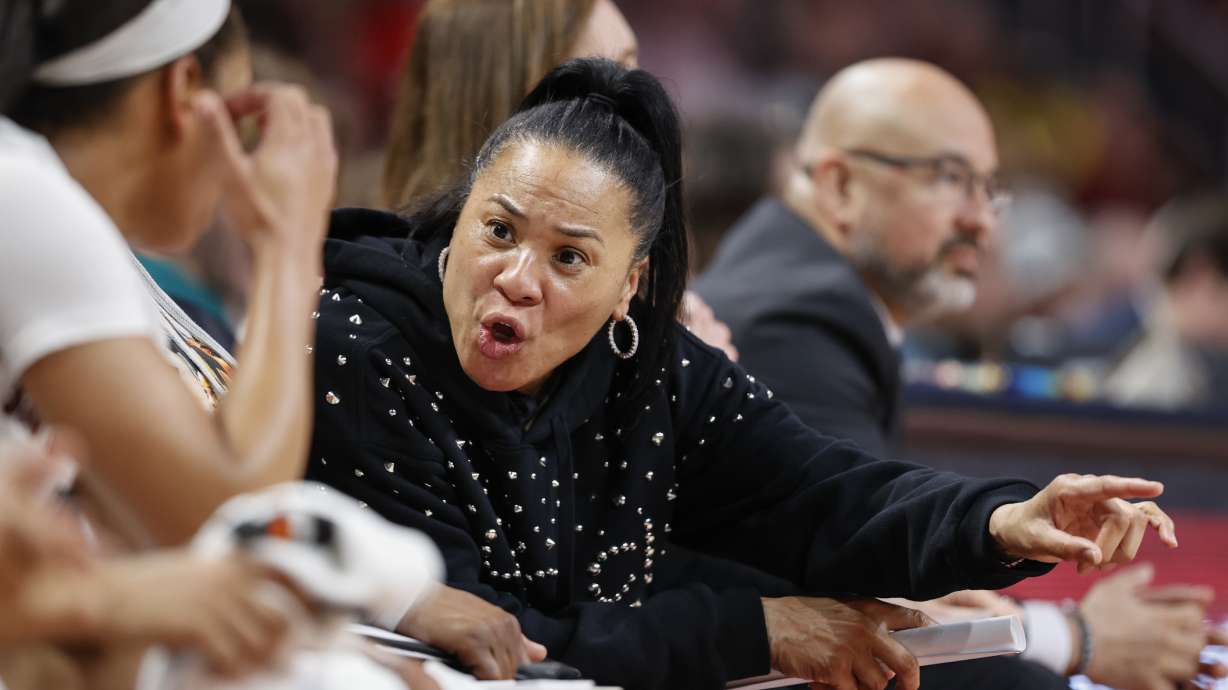South Carolina head coach Dawn Staley talks to players on the bench during the second half of an NCAA college basketball game against Georgia in Columbia, S.C., Sunday, Feb. 26, 2023. South Carolina won 73-63.