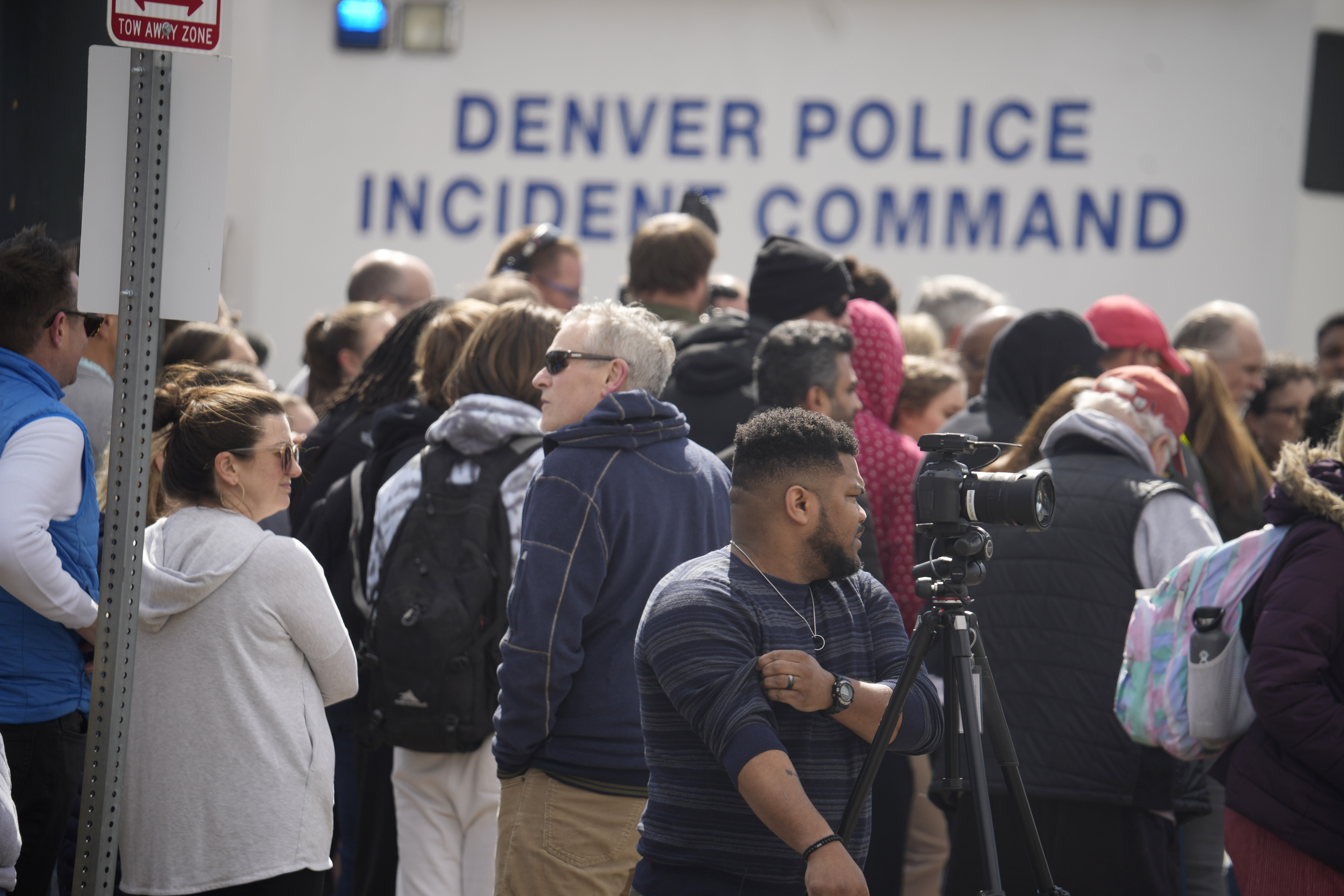 Parents wait for students to be walked out after two administrators shot and wounded after a handgun was found during a daily search of a student at Denver East High School Wednesday in Denver.