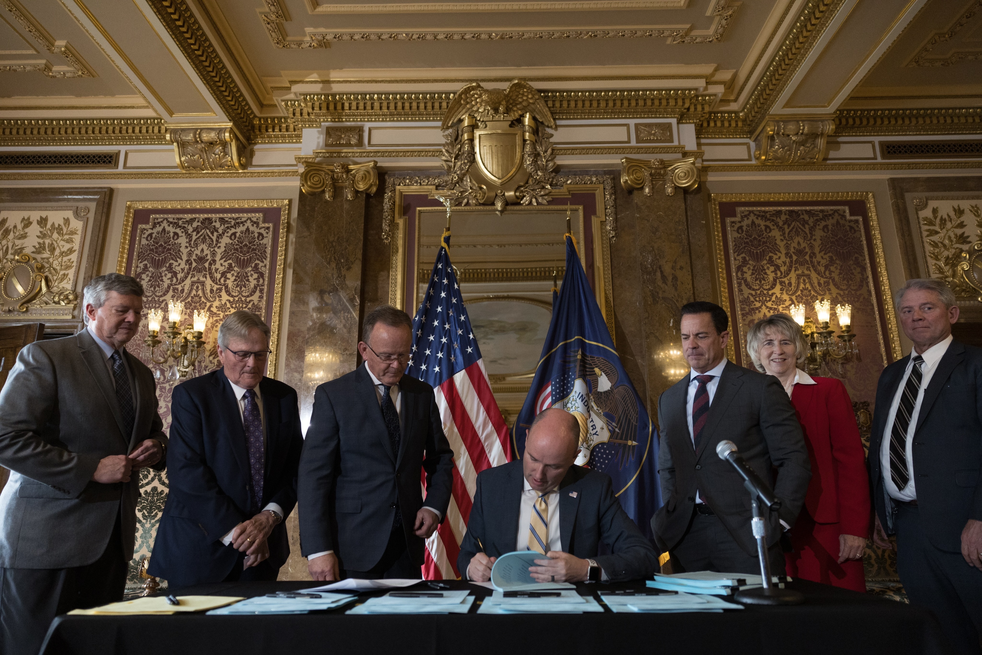 Utah Gov. Spencer Cox signs a record $400 million tax cut into law in the Gold Room at the Capitol on Wednesday.