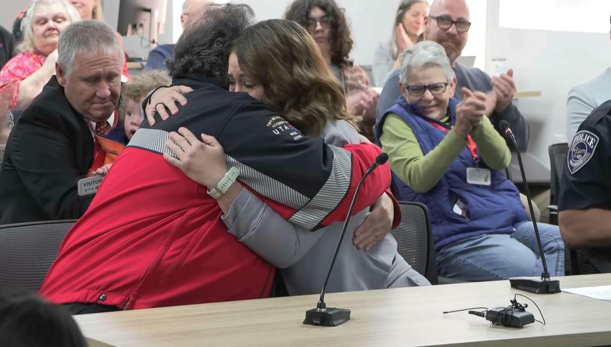Utah Transit Authority bus driver Nick Pappas hugs Marissa Bowen during a Wednesday board meeting at UTA headquarters in Salt Lake City. UTA recognized Pappas for his heroic efforts to save Bowen's life when dogs attacked her.