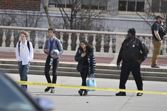 Students leave East High School following a school shooting, Wednesday in Denver. Two school administrators were shot at the high school Wednesday morning after a handgun was found on a student subjected to daily searches, authorities said.