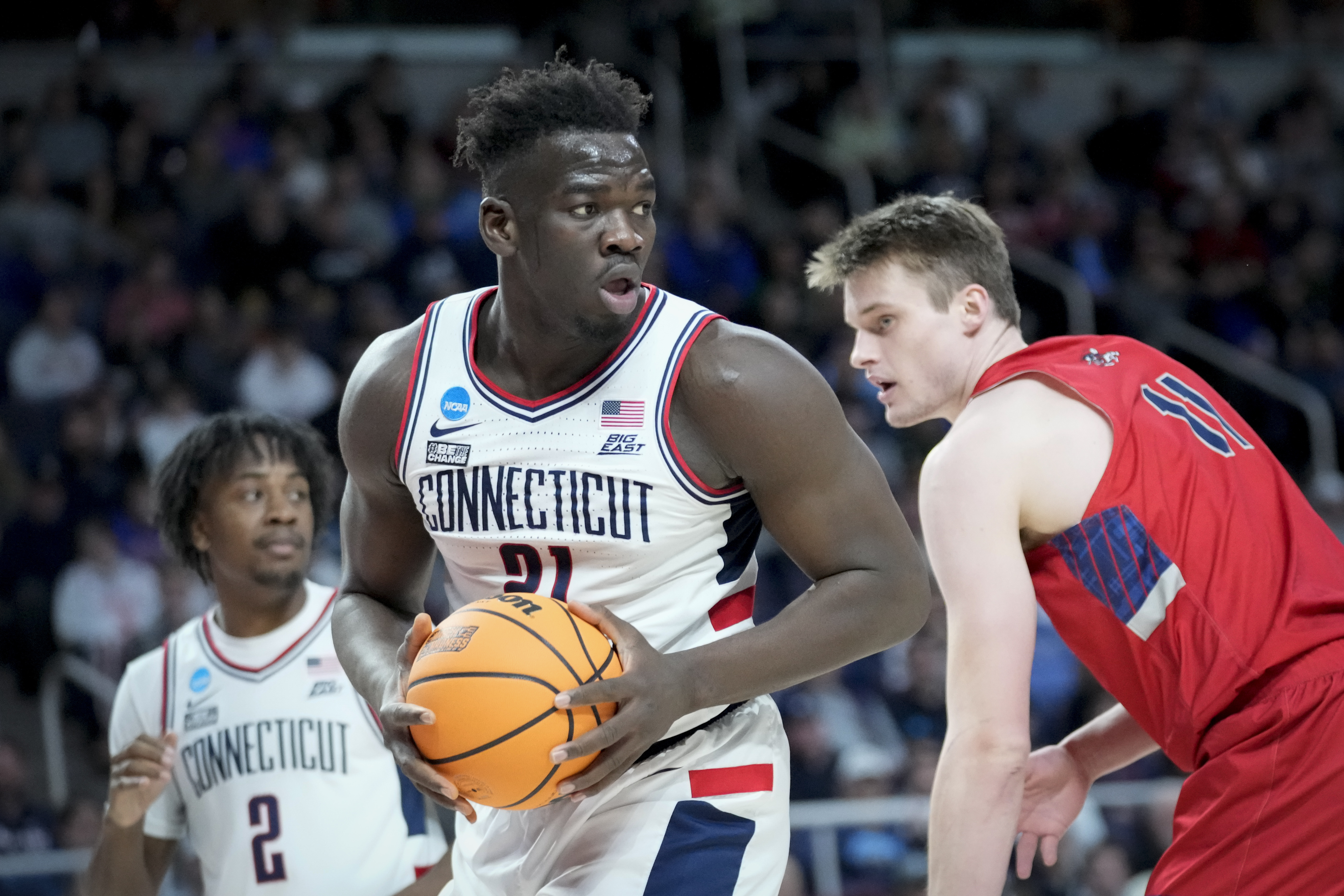 Connecticut's Adama Sanogo (21) looks to pass after rebounding against St. Mary's Mitchell Saxen (11) in the first half of a second-round college basketball game in the NCAA Tournament, Sunday, March 19, 2023, in Albany, N.Y.