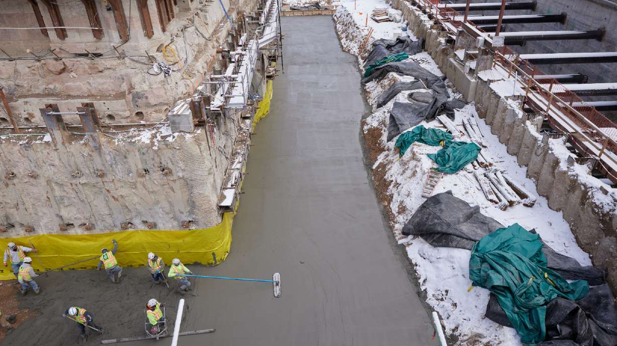 A concrete slab is laid around the perimeter of the Salt Lake Temple to create a clean and level working surface during the multiyear renovation of the temple in Salt Lake City in March.