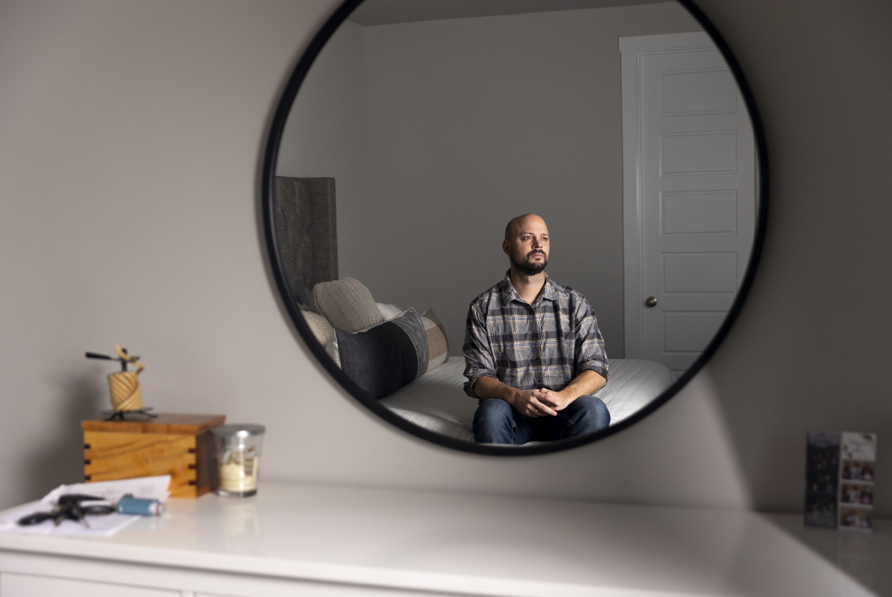 Blake Bockholt poses for a portrait inside of his bedroom in his Syracuse home on Nov. 20, 2022. Bockholt struggles with symptoms from long COVID-19.