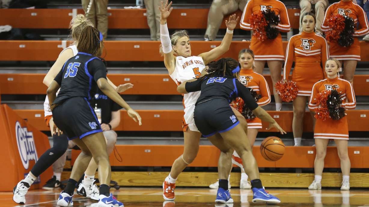 Bowling Green guard Elissa Brett (5) draws a charging foul against Memphis guard Jamirah Shutes (23) during the second half of a WNIT game aat the Stroh Center in Bowling Green, Ohio, Friday March 23, 2023.