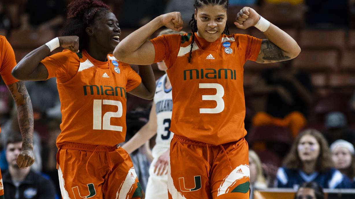 Miami's Ja'Leah Williams (12) and Destiny Harden (3) celebrate after Harden scored against Villanova in the first half of a Sweet 16 college basketball game of the NCAA Tournament in Greenville, S.C., Friday, March 24, 2023.