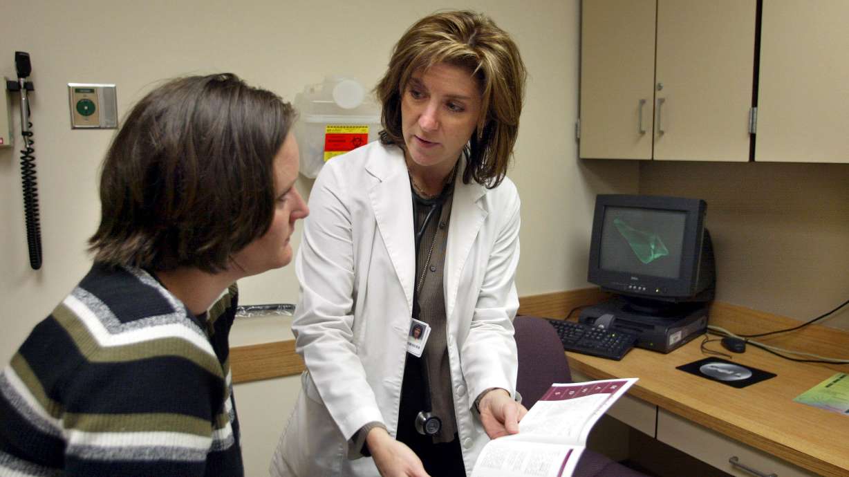 Nurse practitioner Kismet Rasmusson talks with a patient about heart-related care at LDS Hospital on Mar. 7, 2002. A Senate bill passed earlier this month gives full practice authority to nurse practitioners.