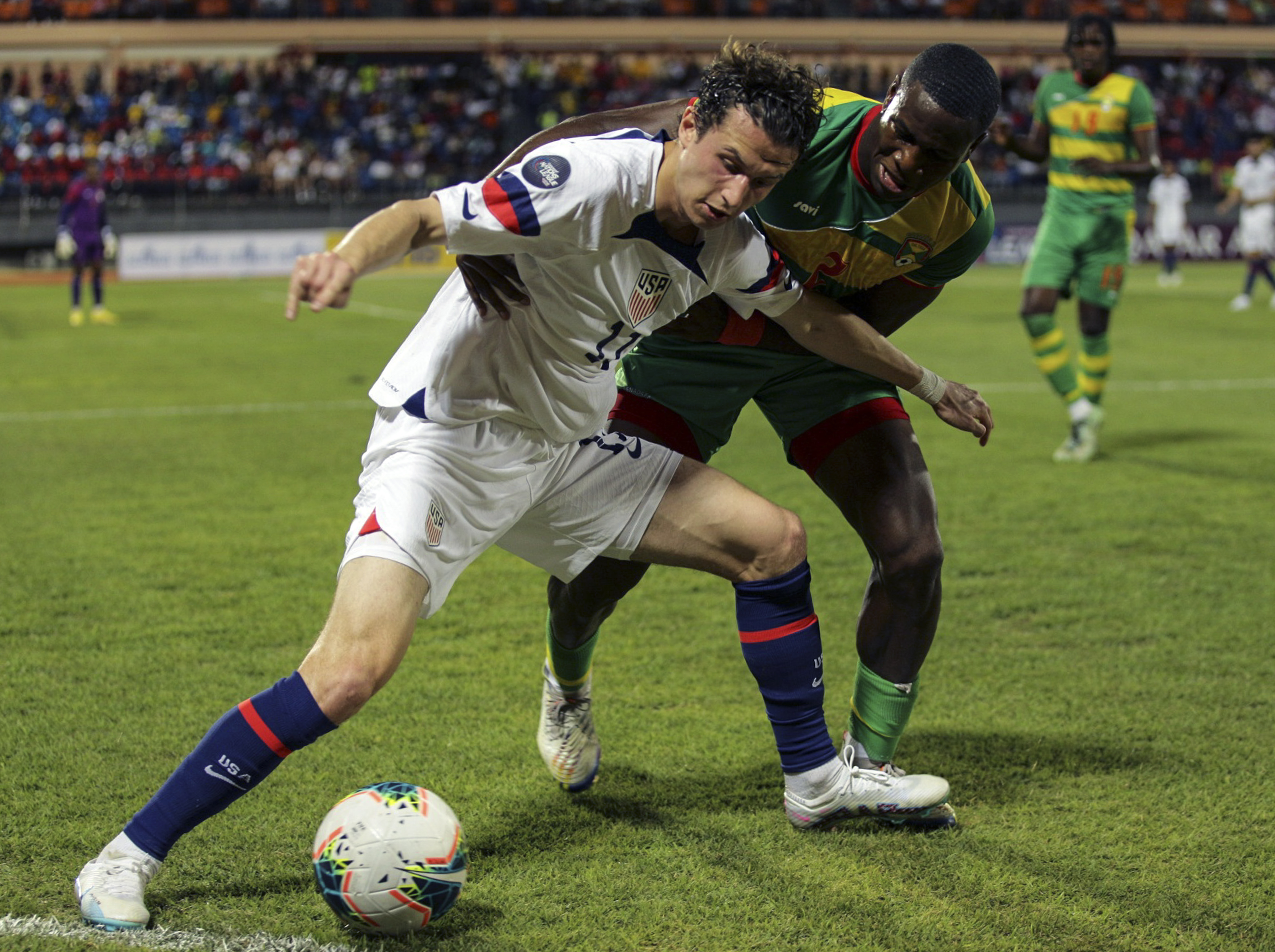 U.S. Brenden Aaronson, left, fights for the ball with Grenada's Benjamin Ettienne, during a CONCACAF Nations League soccer match in Saint George, Grenada, Friday, March 24, 2023.