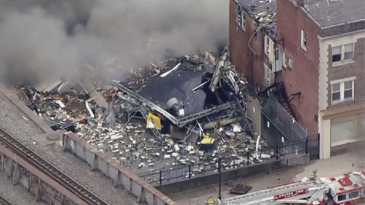 Emergency personnel and heavy equipment work at the site of a deadly explosion at a chocolate factory in West Reading, Pa., Saturday.