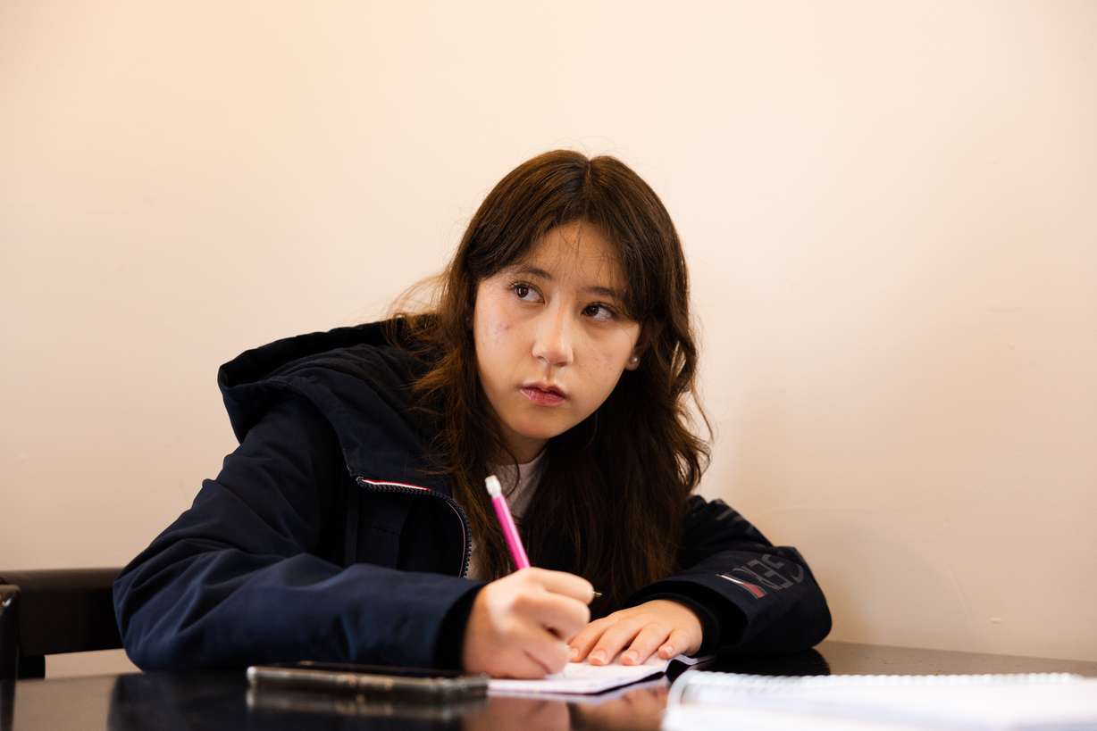 Katie Lens listens during a Korean language lesson at Yummy's Korean BBQ restaurant in West Valley City on March 25.