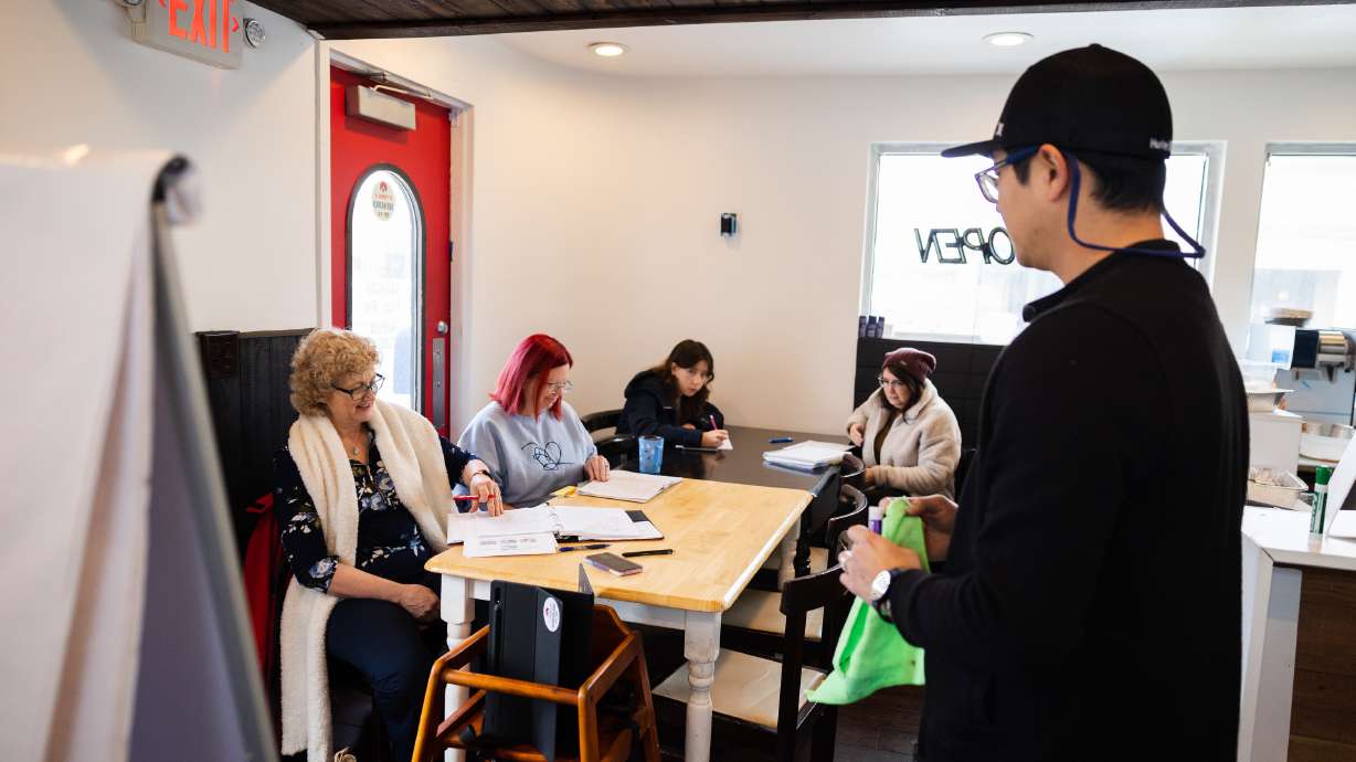 Sun Choi, right, teaches during a Korean language lesson at Yummy's Korean BBQ restaurant in West Valley City on March 25.