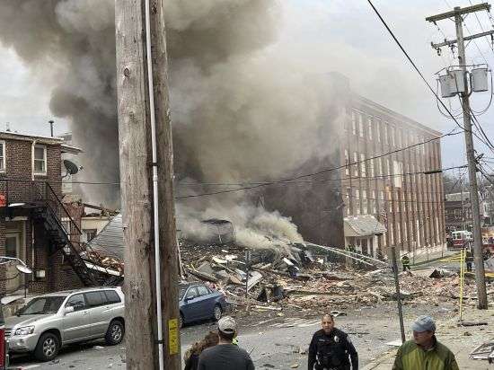 Emergency personnel work at the site of a deadly explosion at a chocolate factory in West Reading, Pennsylvania, Saturday.