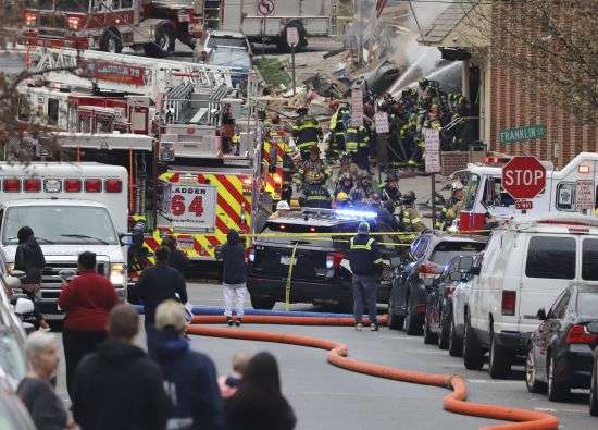 Emergency personnel and heavy equipment work at the site of a deadly explosion at a chocolate factory in West Reading, Pennsylvania, Saturday.