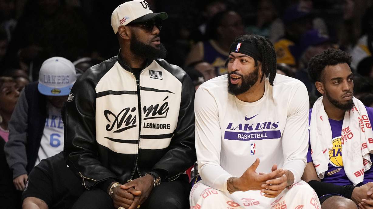 Los Angeles Lakers' LeBron James, left, and forward Anthony Davis chat as they sit on the bench during the first half of an NBA basketball game against the Oklahoma City Thunder Friday, March 24, 2023, in Los Angeles.