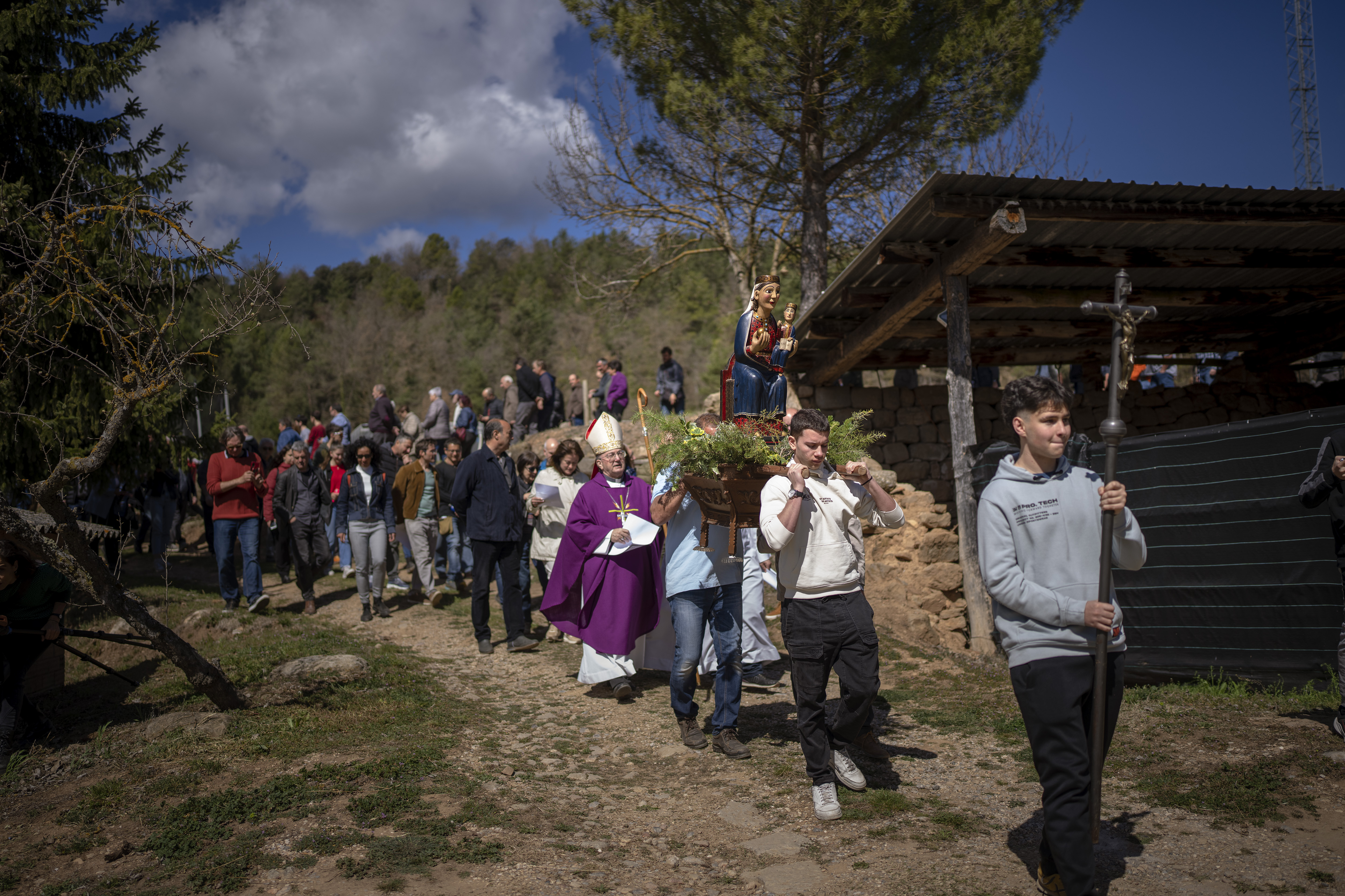 Local residents take part in a procession carrying a replica of the Our Lady of the Torrents, a virgin historically associated with drought, in l'Espunyola, north of Barcelona, Spain, Sunday. Farmers and parishioners gathered to pray for rain.
