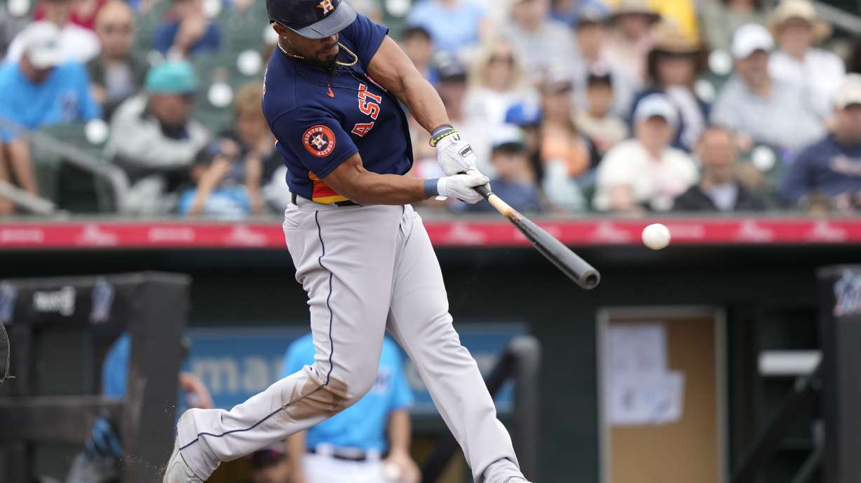 Houston Astros' Jose Abreu hits a double to score Jeremy Pena during the fourth inning of a spring training baseball game against the Miami Marlins, Sunday, March 19, 2023, in Jupiter, Fla.