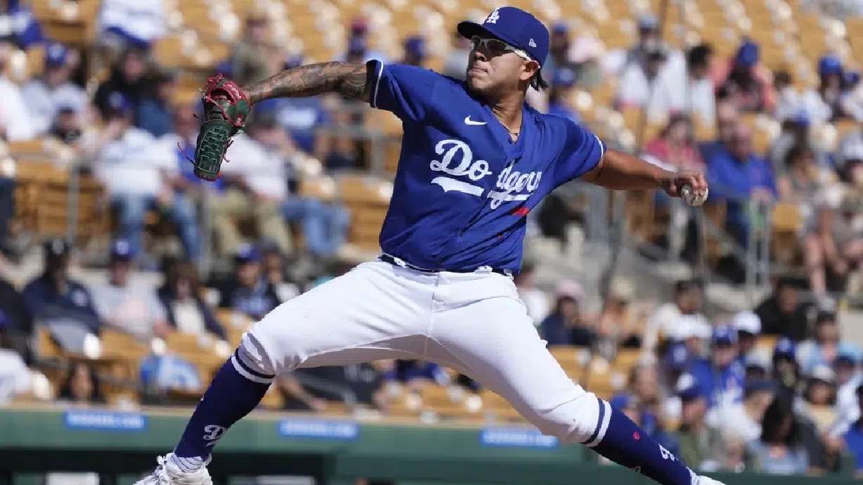 Los Angeles Dodgers pitcher Julio Urias throws a pitch against the Cincinnati Reds in the second inning of a spring training game Feb. 28 in Phoenix. It went to a dog.