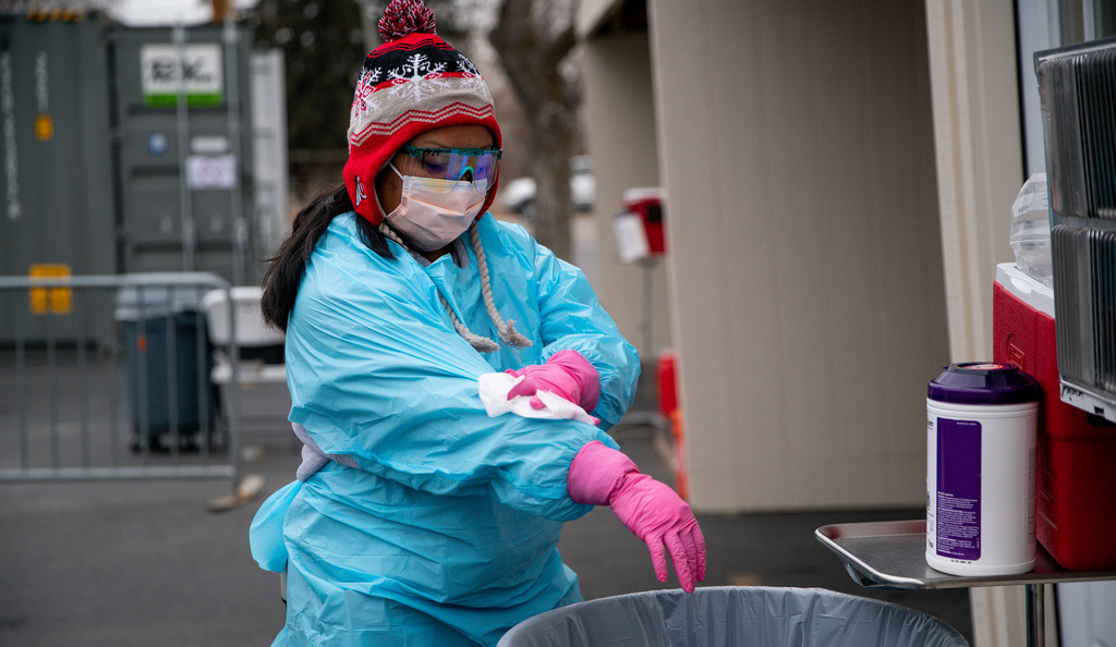 Certified medical assistant Ester Ortiz wipes down her personal protective equipment at a drive-thru COVID-19 testing site in Salt Lake City on Dec. 11, 2020. The pandemic brought on a surge in the use of bleach and disinfectant spray and wipes. 