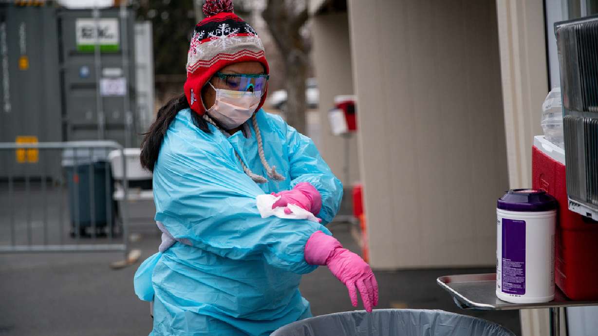 Certified medical assistant Ester Ortiz wipes down her personal protective equipment at a drive-thru COVID-19 testing site in Salt Lake City on Dec. 11, 2020. The pandemic brought on a surge in the use of bleach and disinfectant spray and wipes.