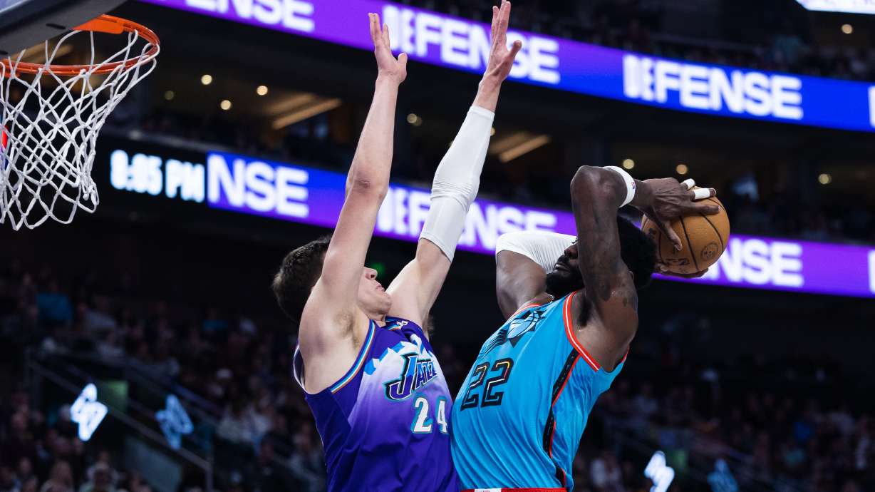 Phoenix Suns center Deandre Ayton (22) attempts to dunk on Utah Jazz center Walker Kessler (24) during an NBA game against the Phoenix Suns at Vivint Arena in Salt Lake City on March 27, 2023.