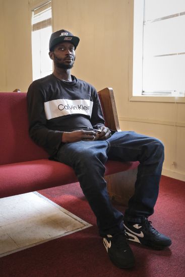 Michael Corey Jenkins sits on a pew in Taylor Hill Church in Braxton, Mississippi on March 18. The police shooting of Jenkins, who sustained critical injuries after he says a deputy put a gun in his mouth and fired, led the Justice Department to open a civil rights investigation into the Rankin County Sheriff's Office. Deputies said Jenkins was shot after he pointed a gun at them.