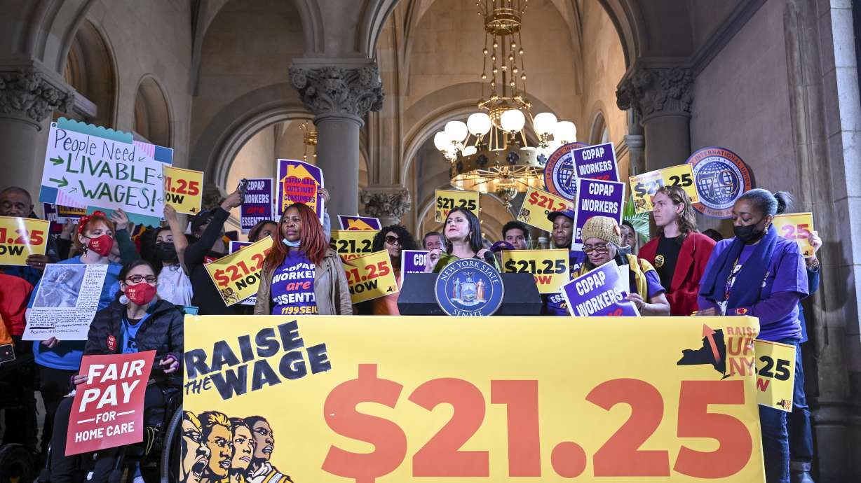 New York Sen. Jessica Ramos, D-East Elmhurst, stands with protesters urging lawmakers to raise New York's minimum wage during a rally at the state Capitol, March 13 in Albany, New York.