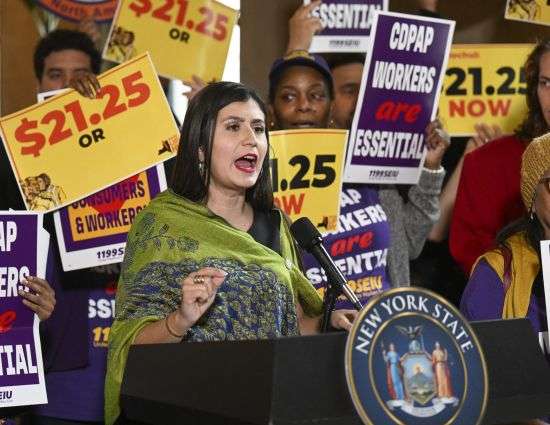 New York Sen. Jessica Ramos, D-East Elmhurst, stands with protesters urging lawmakers to raise New York's minimum wage during a rally at the state Capitol, March 13 in Albany, New York.