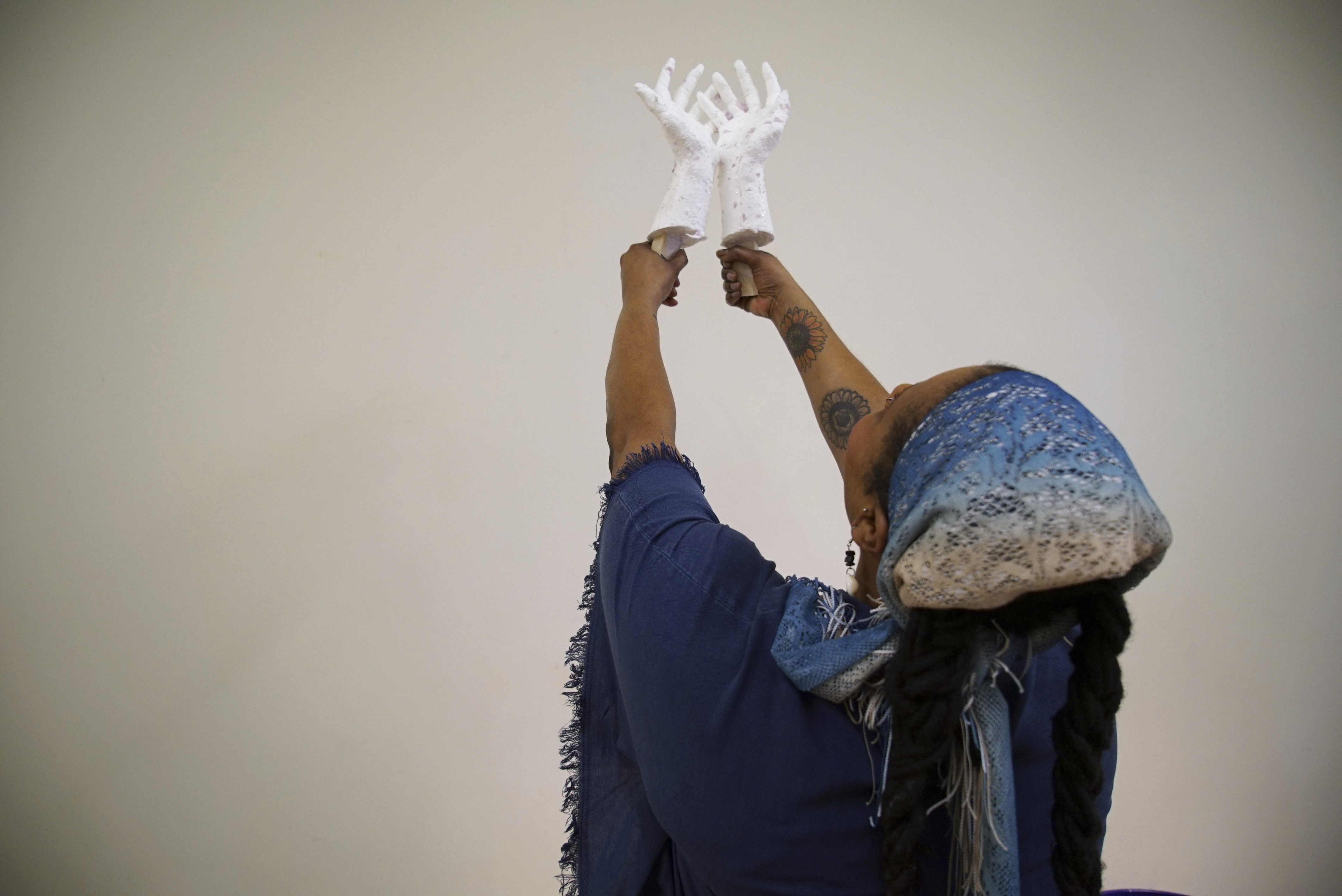 Crystal Kornickey holds up casts of her hands at the Gibbes Museum of Art in Charleston, S.C.. She is one of 36 people whose hands will be cast in bronze for a memorial to the likely enslaved people discovered in an unmarked burial ground.