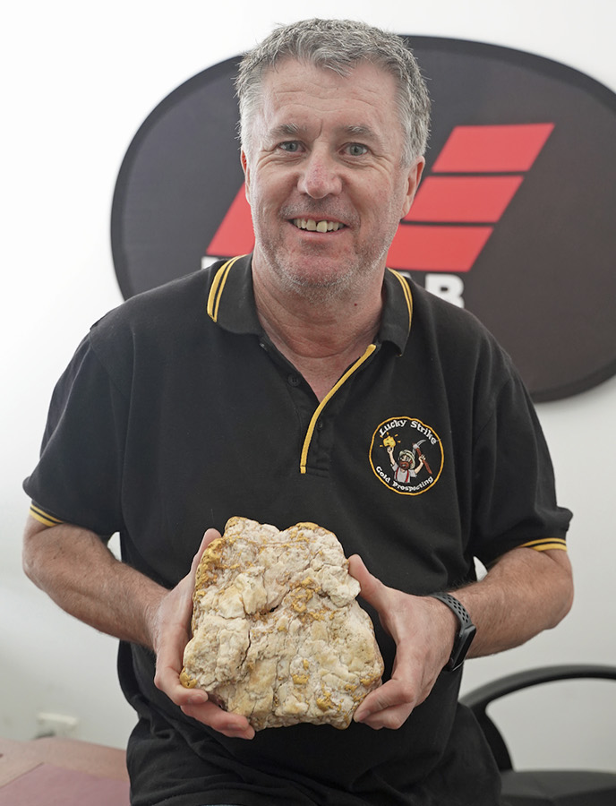 Business owner Darren Kamp holds the gold-filled rock. It weighs 10.1 pounds, with the precious metal making up 5.7 pounds. The man who discovered it has not been named.